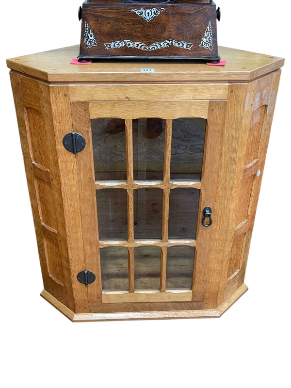In the manner of Thompsons of Kilburn adzed Yorkshire oak glazed panel door corner wall cabinet, 79cm.