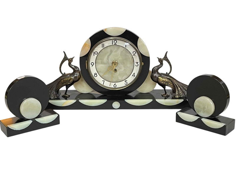 Art Deco style three piece clock garniture set, the clock flanked by pea hens.