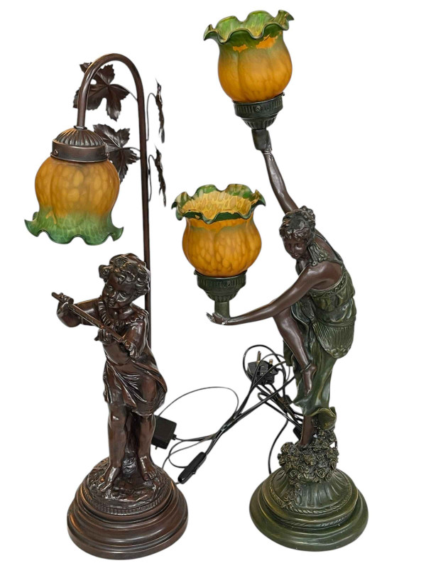 Two figural table lamps with decorative shades.