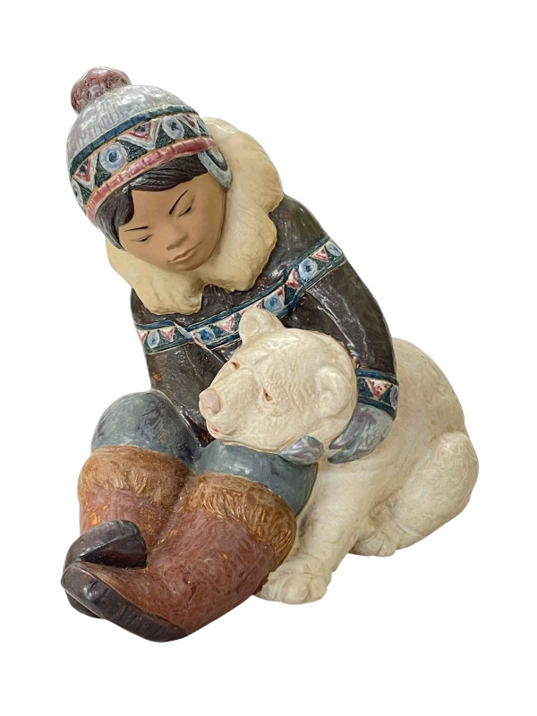 Lladro group 'Eskimo boy with polar bear' 23cm high.