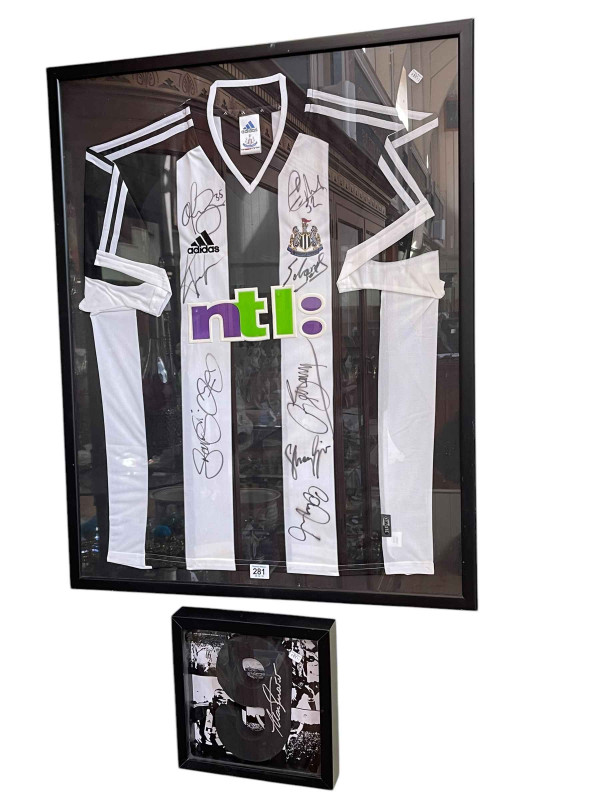 Framed Newcastle United football team shirt. Together with Alan Shearer No. 9, re printed photographs and a signed Bobby Robson 'England v Brazil' 1987 programme with ticket stub.