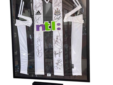 Framed Newcastle United football team shirt. Together with Alan Shearer...