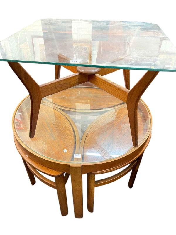 A Younger Ltd mid Century teak long john sideboard, circular teak glazed top coffee table nest of tables and teak glazed top coffee table (3).