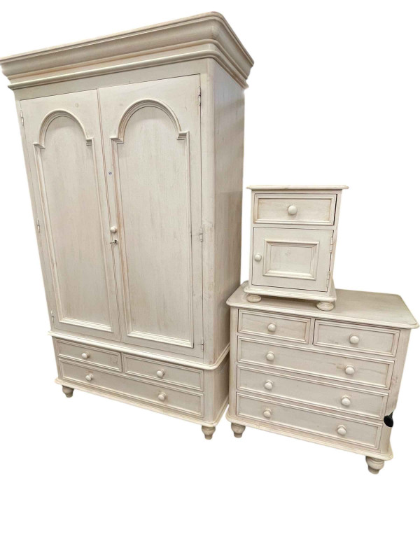 White washed three piece bedroom suite comprising two door wardrobe with three base drawers, chest of two short above three long drawers and pedestal cupboard.