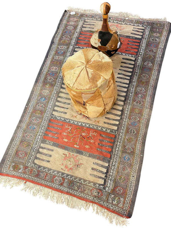 Anatolian rug 1.65 by 0.98, skin pouffe and Cognac bottle (3).