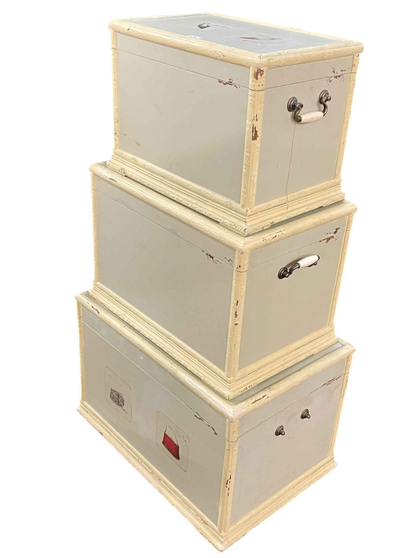 Set of three graduated trunks, largest 41cm by 61cm by 42cm.