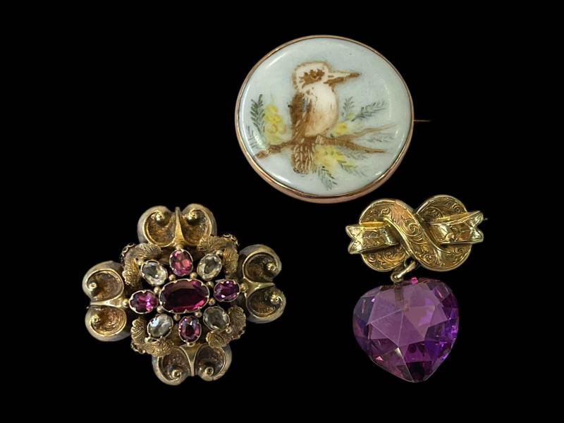 Two Victorian gold brooches and painted porcelain bird brooch (3).