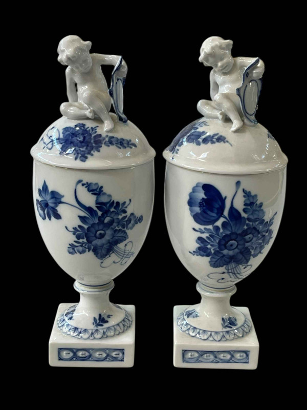 Pair Royal Copenhagen blue and white covered vases with cherub finials, 28.5cm.