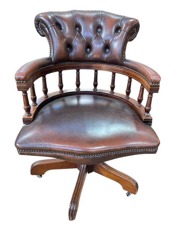 Brown buttoned leather captains style swivel office desk chair.