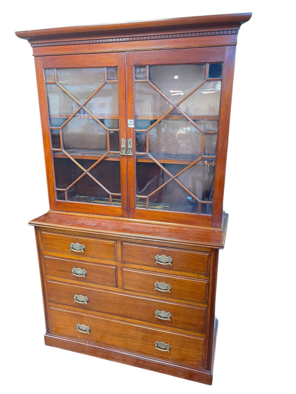 Late Victorian cabinet bookcase having two astragal glazed doors above four short and two long drawers, 203cm x 125.5cm x 52.5cm.