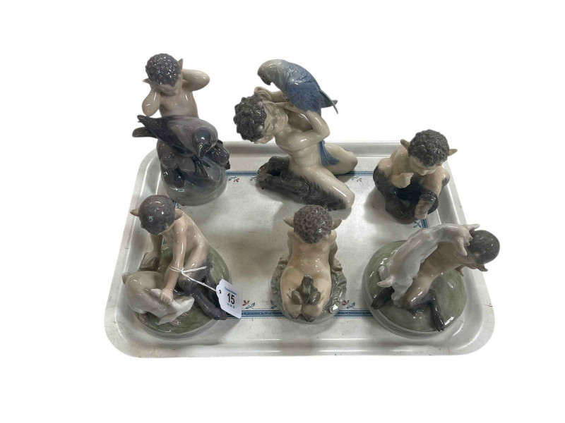 Six Royal Copenhagen Faun figures, all with creatures.
