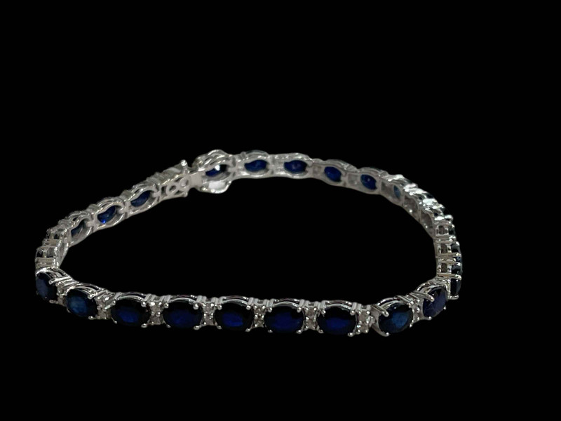 Sapphire and diamond tennis style bracelet set in 18 carat white gold.