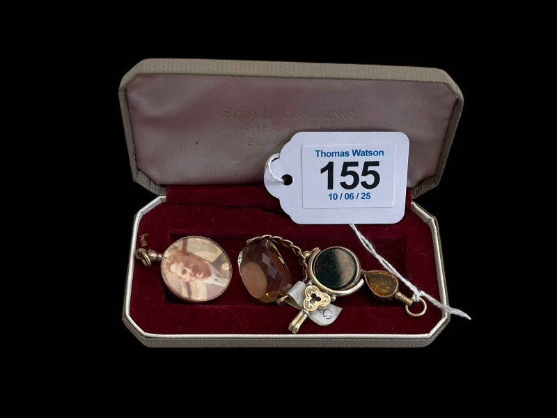 Two 9 carat gold swivel fobs, 9 carat gold photo locket, and 19th Century watch key (4).