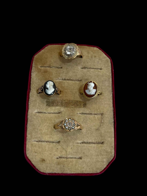 Four gold rings including diamond and seed pearl and two cameo.