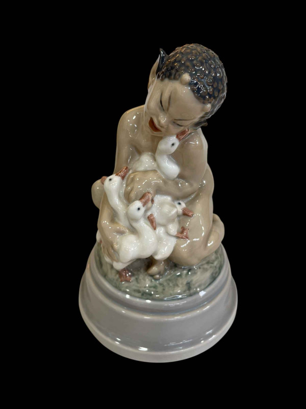 Royal Copenhagen Dahl Jensen figurine of a Faun Holding a Group of Ducklings, model No 1198, 25cm.