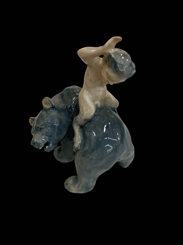 Royal Copenhagen figurine of Faun Riding a Bear, designed by Christian Thomsen, model No 976.