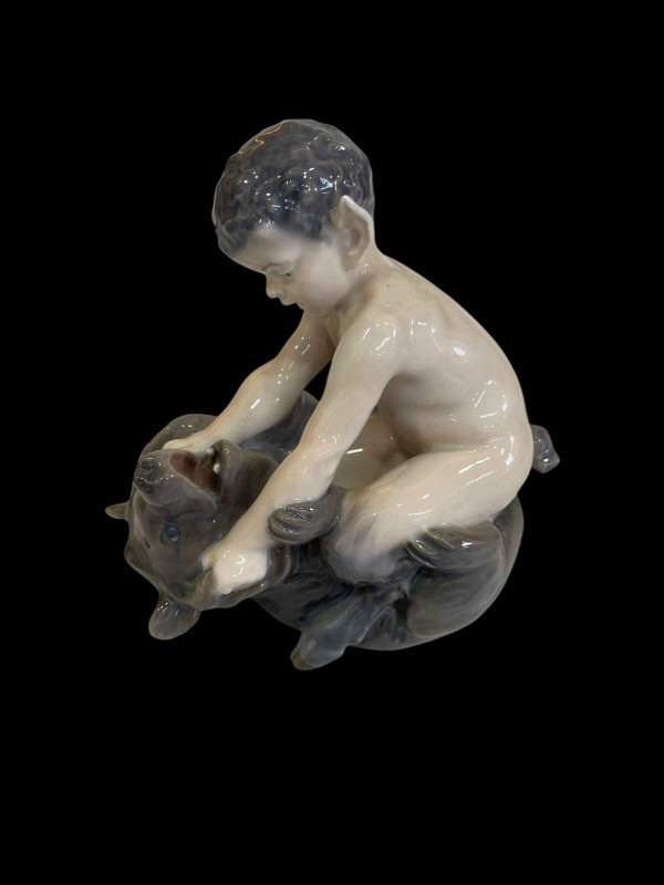 Royal Copenhagen figurine of a Faun on a Bear, designed by Christian Thomsen, mode No 648.
