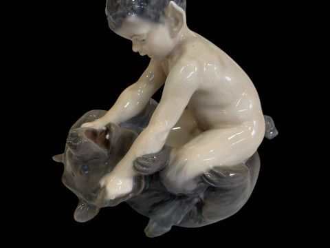 Royal Copenhagen figurine of a Faun on a Bear, designed by Christian Thomsen,...