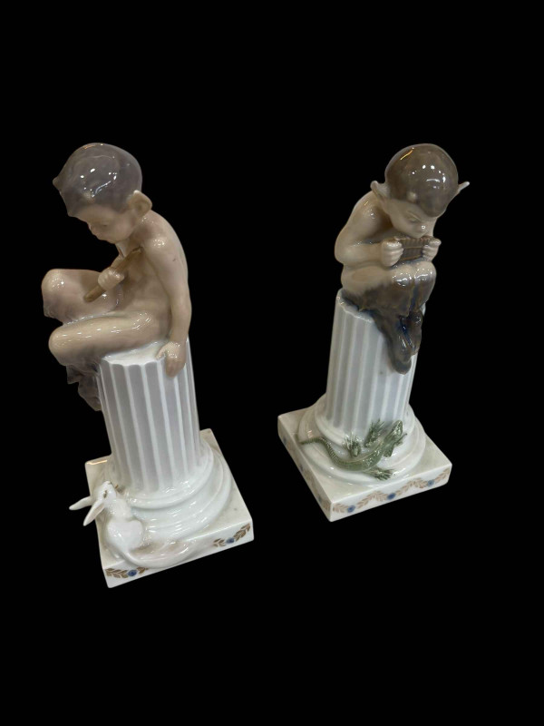 Royal Copenhagen pair of Fauns on column with Lizard and Rabbit designed by Christian Thomsen, model No 433 & 456.