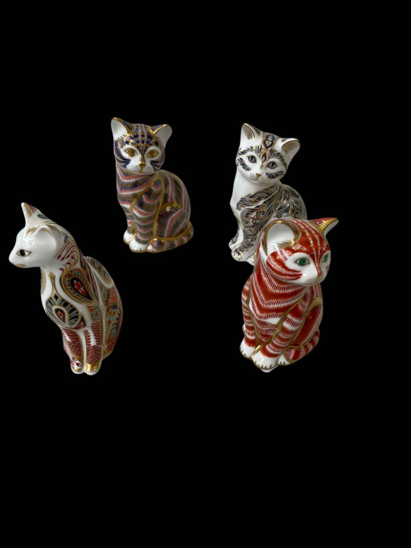 Four Royal Crown Derby cat paperweights.