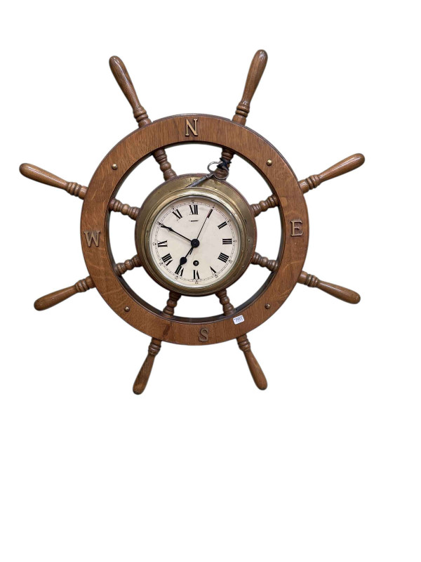 Eight-spoke ship's wheel clock.