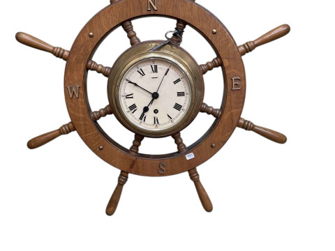 Eight-spoke ship's wheel clock.