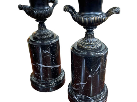 Pair of bronze urns on marble plinths, 31cm high.
