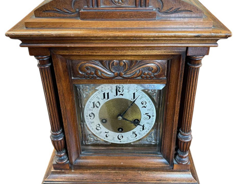Ornate oak mantel clock with gilt dial, 48cm high.