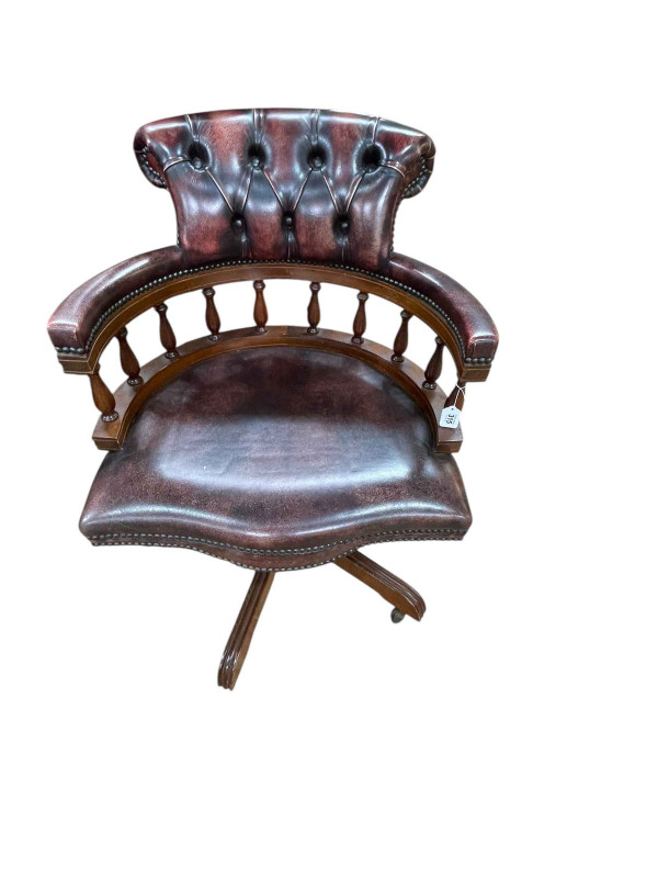 Cherry deep buttoned leather and studded Captains style swivel desk chair.