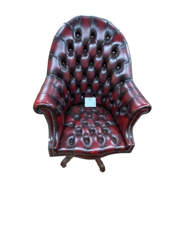 Ox blood deep buttoned leather and studded swivel desk chair.