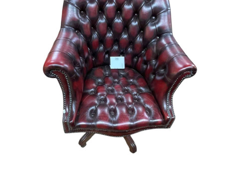 Ox blood deep buttoned leather and studded swivel desk chair.