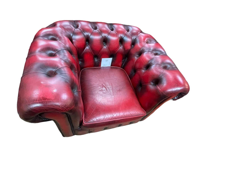 Red buttoned leather and studded Chesterfield armchair.