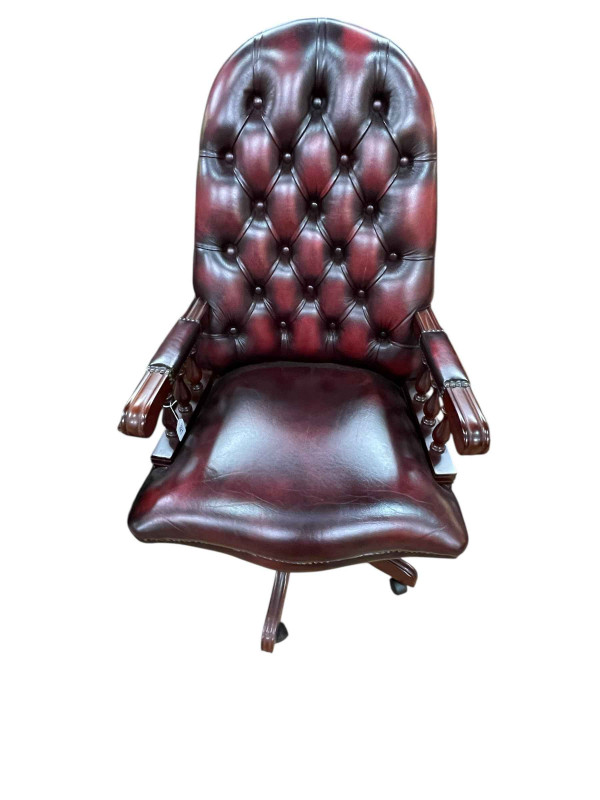 Ox blood deep buttoned leather and studded swivel desk chair.
