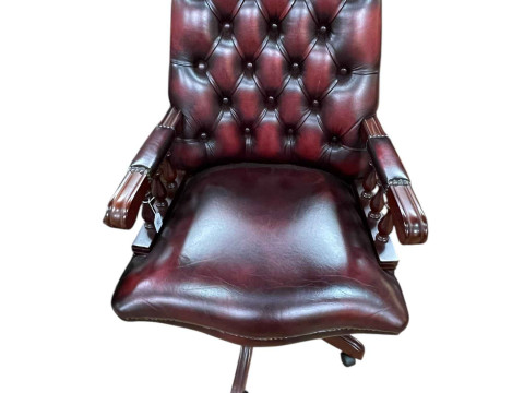 Ox blood deep buttoned leather and studded swivel desk chair.