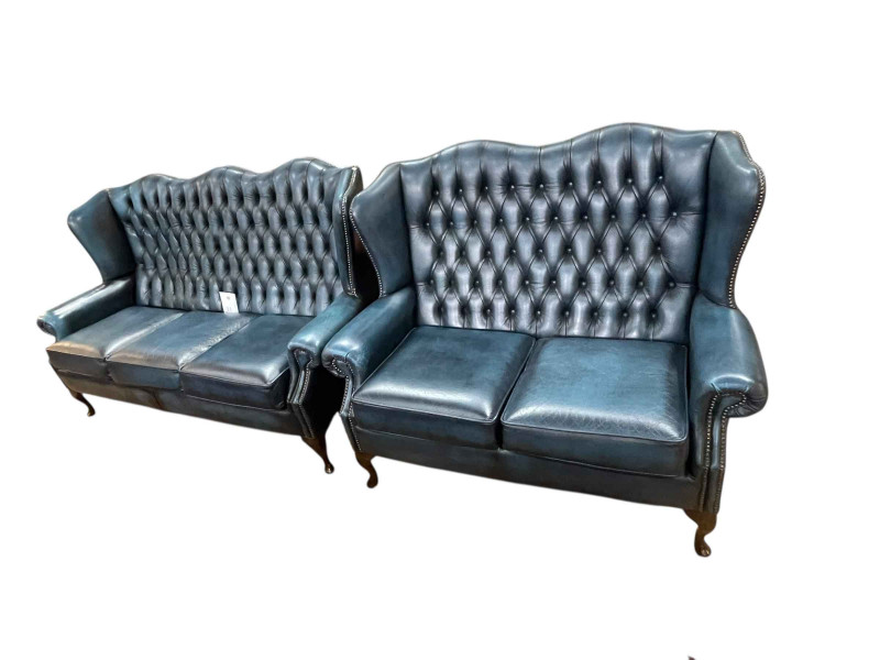 Pair blue deep buttoned leather wing backed three seater and two seater settee's.
