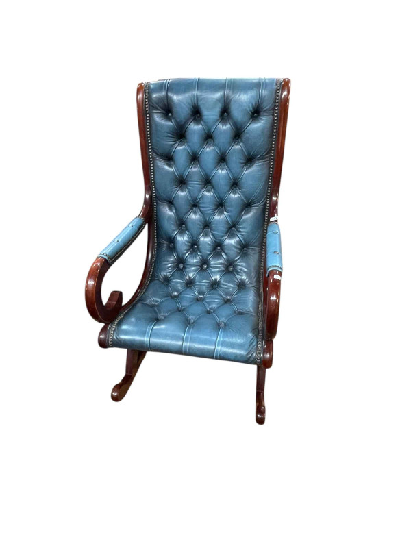 Blue deep buttoned leather scroll arm rocking chair.