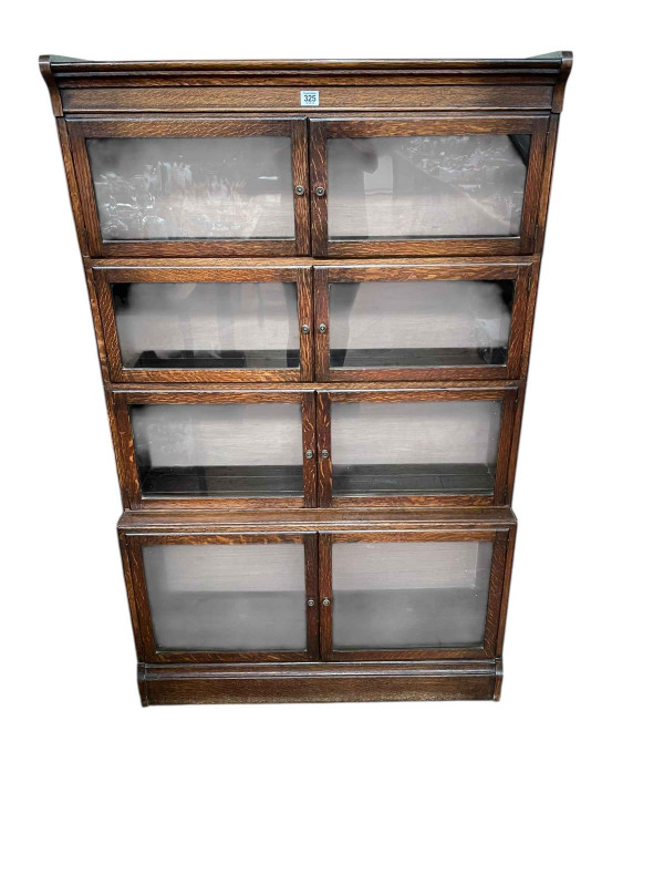 Early 20th Century oak four height bookcase having eight glazed panel doors, 141cm by 89cm by 31cm.