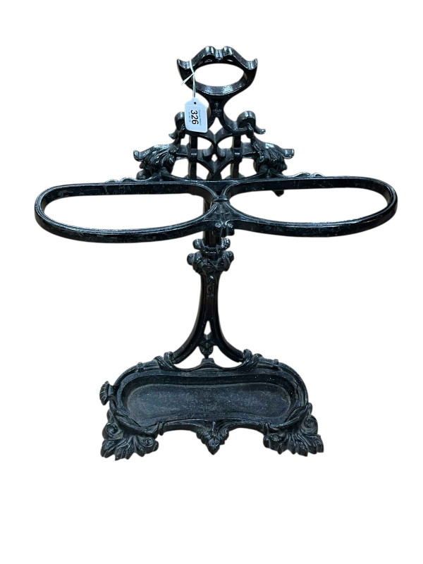 Cast iron two division stick stand, 71cm by 50cm by 17cm.