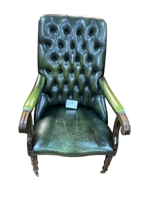 Green buttoned leather and studded turned leg library chair.