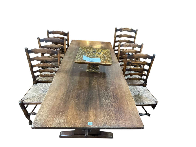 Titchmarsh and Goodwin oak refectory dining table, 75.5 cm by 80.5cm by 183cm together with a set of six rush seated ladder back dining chairs including one carver.