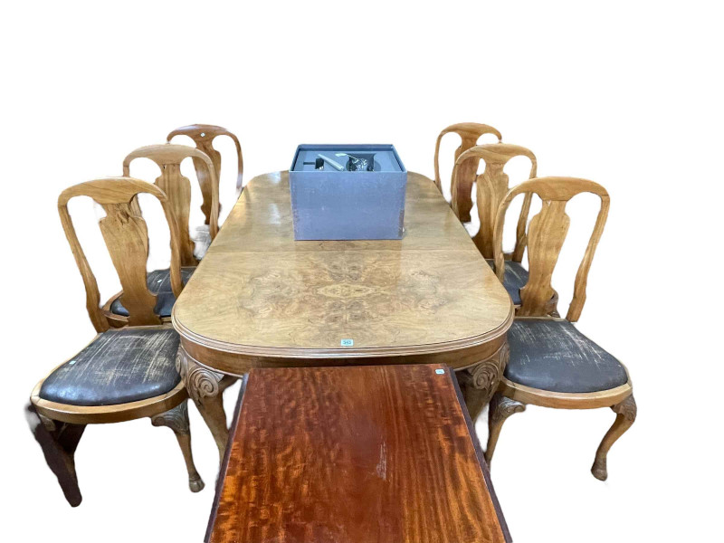 Early 20th Century walnut eight piece dining suite comprising bow end sideboard, extending dining table, leaf and winder and six dining chairs.