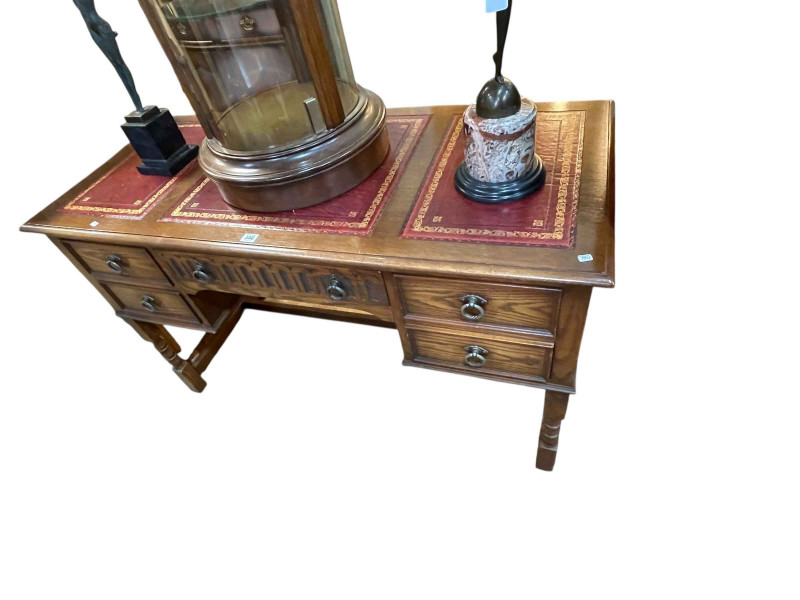 Jaycee oak five drawer writing table, 76.5cm by 128cm by 57cm.