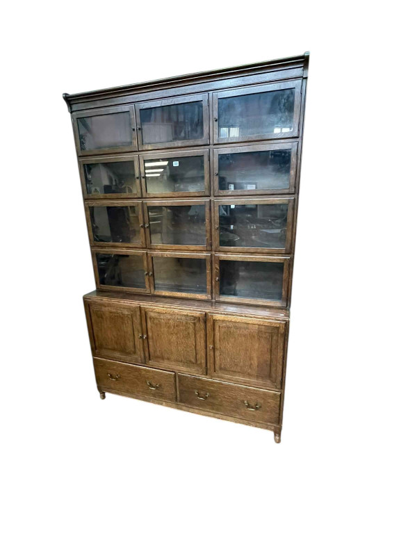 Early 20th Century Minty oak bookcase having twelve glazed panel doors above three cupboard doors with two drawers below, 204cm by 133.5cm by 37cm.
