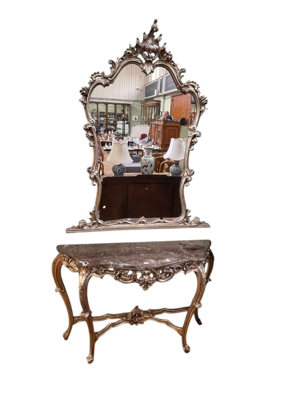 Marble topped serpentine shaped front silvered console table 83cm by 129cm by 44cm together with a matching arched top mirror, 146cm by 120cm.