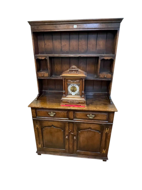 Titchmarsh & Goodwin style oak dresser and rack, the two tier open rack having two small drawers above a base of two drawers and two arched fielded panel doors, 178cm by 106.5cm by 45cm.
