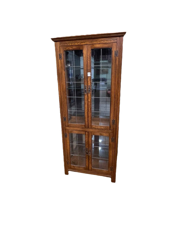 Oak display cabinet having four leaded glazed panel doors, 178cm by 80cm by 37cm.