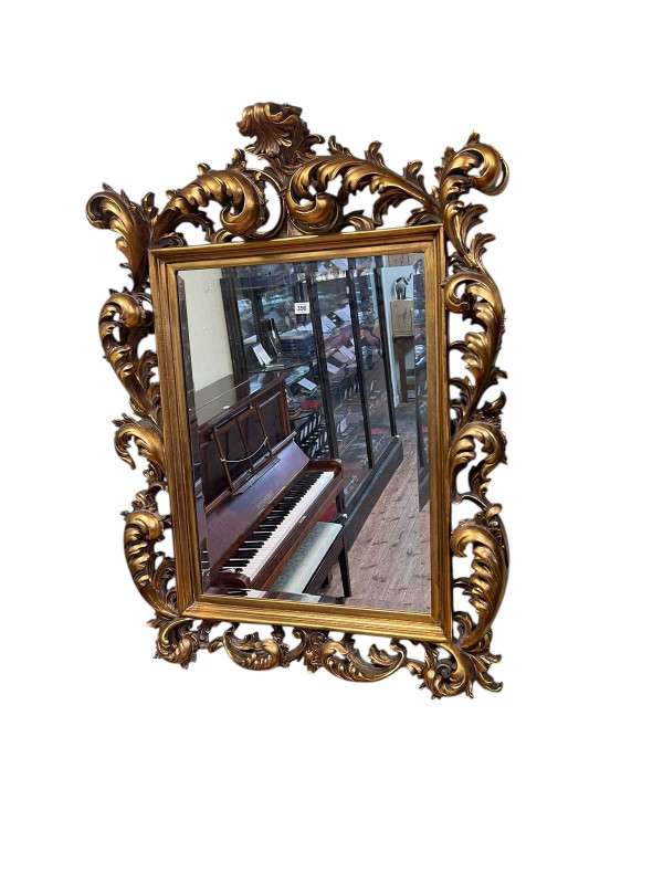 Gilt framed Rococco style bevelled wall mirror, 120cm by 87cm.