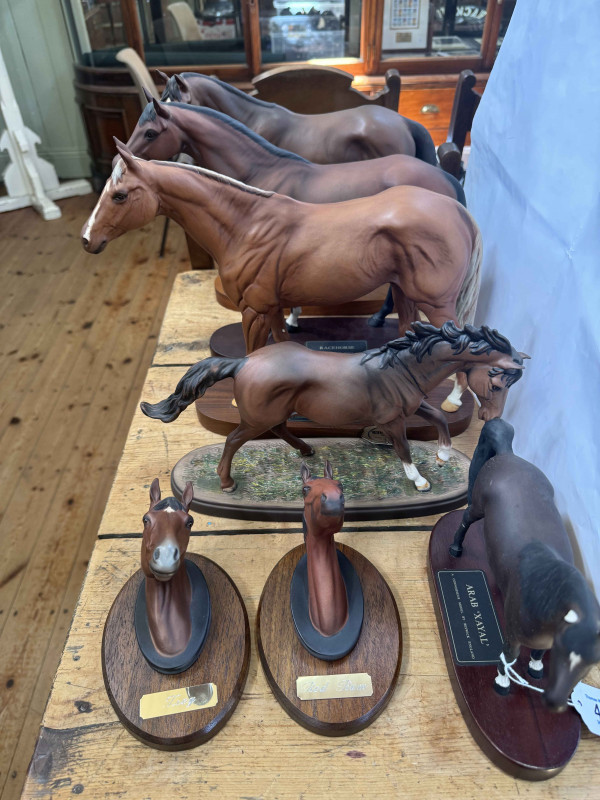 Four Beswick horses including Troy, Grundy, Racehorse and Arab Xayal, Red Rum and Troy Head wall plaques and Royal Doulton 'The Winner' (7).