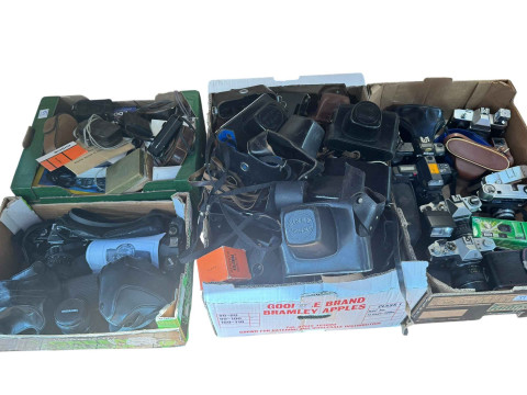 Five boxes of cameras, cases, lenses and accessories.