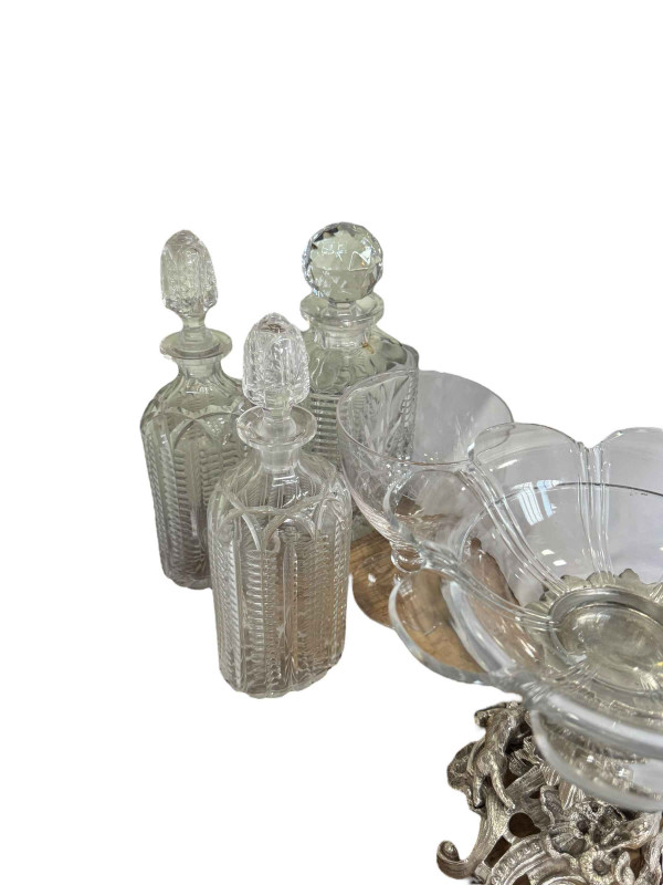 EPNS and glass centre piece, three decanters, engraved jug and large stemmed glass.